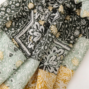 Detailed macro shot of vintage floral cotton-feel scarf with green and ginger prints