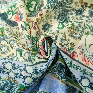 Close-up of soft green floral bohemian print cotton linen scarf with intricate paisley patterns