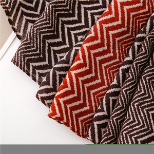 Close-up of zigzag chevron pattern scarf in dark brown, cream, and brick red weave