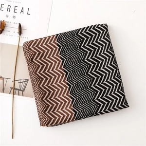 Macro detail of high-quality wavy knit scarf with coffee and black contrast pattern
