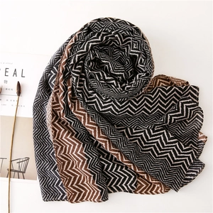 Close-up of bohemian style chevron scarf with black and brown wavy patterns and magazine