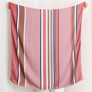 Flat lay detail showing vertical stripes and fine geometric patterns on cotton linen scarf