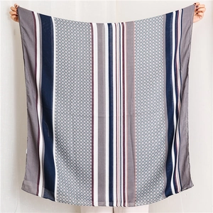 Detail of light cotton linen scarf with blue and grey striped geometric pattern