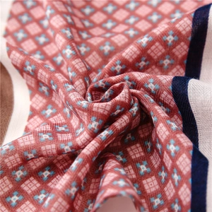 Detail view of cotton linen scarf showing geometric floral patterns and soft fabric texture