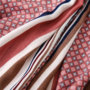 Macro detail of the woven twill texture and geometric floral pattern on the cotton linen scarf