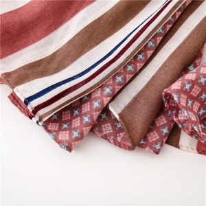 Close-up of the vintage linen texture and striped floral pattern on this soft summer shawl