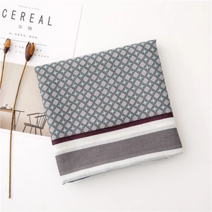 Detail of linen-feel floral scarf with grey-blue geometric pattern and striped border