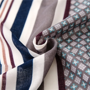 Close-up of cotton linen scarf showing striped patchwork and geometric star patterns