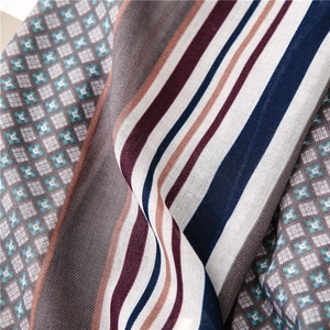 Detail of twill woven cotton linen scarf with plaid patterns and multi-color stripes