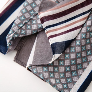 Detail shot of multi-color striped linen scarf with geometric floral patterns and textures