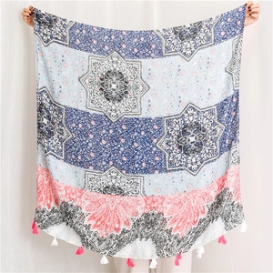 Detail of floral shawl with mandala pattern and colorful fringe tassels on edges