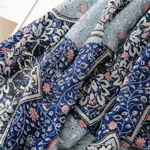 Detailed macro view showing the textured floral fabric and woven cotton linen blend