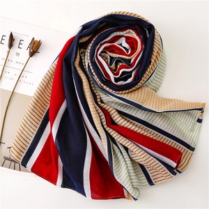 Detailed close-up of a striped colorful scarf with navy red and white cotton texture