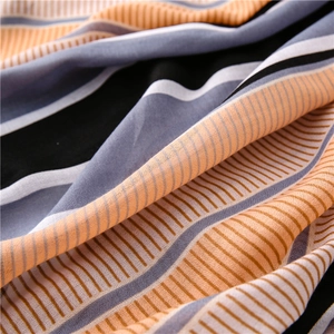 Macro shot of striped fabric with orange and purple bands showing soft texture and drape