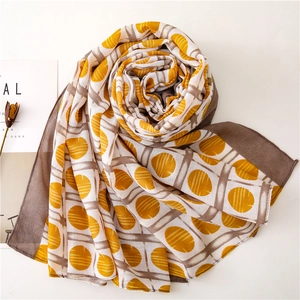 Detailed texture of lightweight yellow polka dot and brown grid chiffon scarf fabric