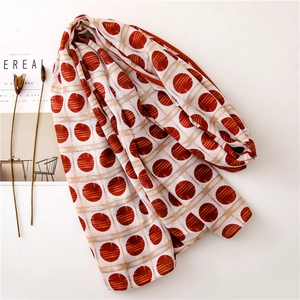 Flat lay of retro polka dot scarf with grid pattern next to Cereal magazine