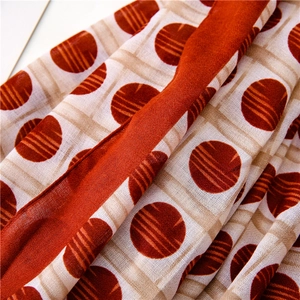 Detailed macro view of orange polka dot pattern on natural cotton linen fabric texture