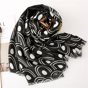 Lightweight black scarf with white geometric patterns and natural raw fringe edges