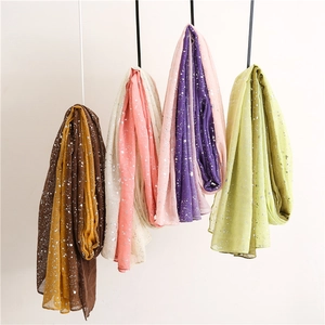 Detailed view of lightweight cotton linen scarves featuring silver foil gradient prints