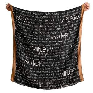 Black and brown winter scarf with stylish white script letters shown fully open