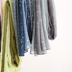 Close-up of cotton linen scarves featuring silver gradient print in various colors