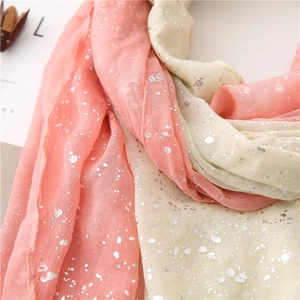 Detail of pink and beige gradient scarf showing silver foil texture and soft fabric