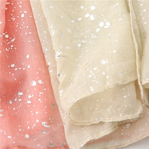 Macro detail of bicolored cotton linen scarf with sparkling silver gradient foil texture