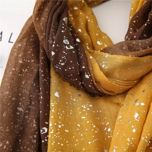 Detail of coffee and yellow gradient linen scarf with shiny silver foil stamping texture