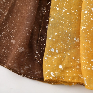 Detail showing gradient fabric texture with silver foil dots in brown and yellow tones