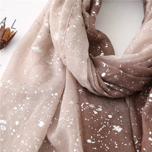 Detail of gradient cotton linen scarf with silver sparkle print and soft fringe