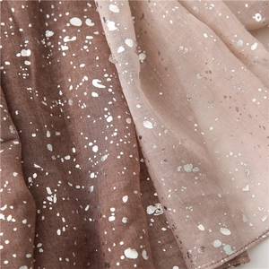 Close-up of gradient cotton linen scarf with silver foil details from brown to pink