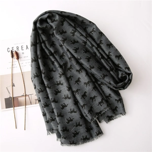 Dark grey floral scarf with horse print and frayed edges on a minimalist white backdrop