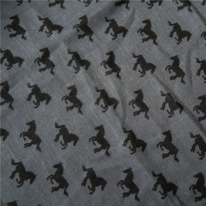 Close-up of dark grey cotton linen fabric texture with black rearing horse print pattern