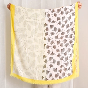 Detail of bohemian sun shawl featuring ginkgo leaf patterns and yellow fringed edges