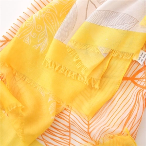 Detail of 100% viscose scarf with yellow pop art print and fine tassel edges