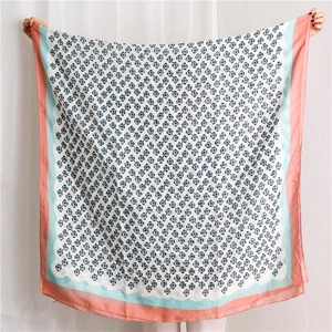 Detail of floral print scarf showing lightweight translucent fabric and colored borders