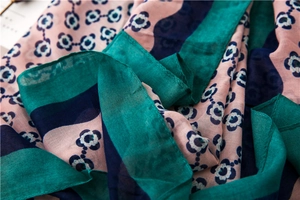 Close-up of lightweight floral cotton linen scarf with soft pink and blue flower patterns