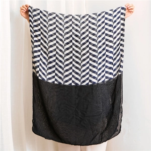 Detail showing blue chevron pattern spliced with sheer black fabric on a long shawl