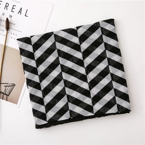 Detail of soft black and white grid patterned scarf with premium linen texture