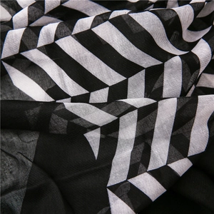 Detail of soft breathable black and white striped scarf with refined woven texture