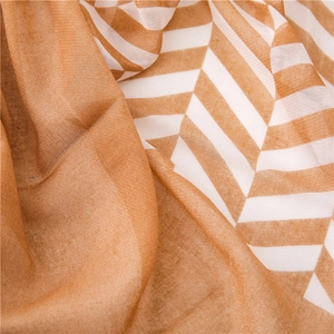 Detail of soft lightweight scarf fabric with tan and white herringbone pattern texture