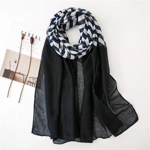 Blue geometric pattern and black chiffon scarf for women in a flat lay minimalist scene