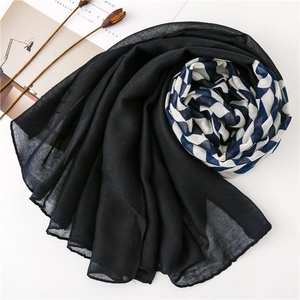 Macro view of blue and white zigzag patterned woven scarf with soft translucent texture