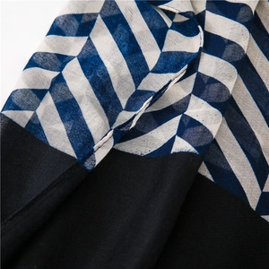 Detail view of woven striped texture and geometric pattern on lightweight summer scarf