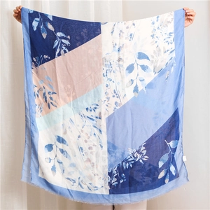 Floral print cotton linen scarf with blue leaf pattern and frayed edges for women