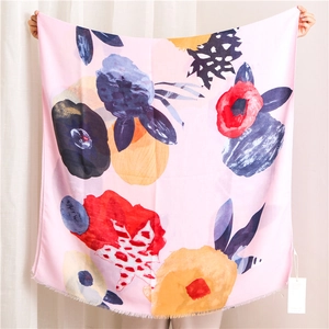 Detail of thin rectangular scarf with ink painting floral print and fringed edges