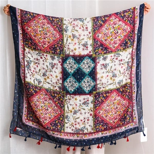 Detailed view of paisley print cotton linen scarf featuring colorful tassel edges and floral patterns