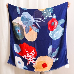 Close-up of lightweight ethnic scarf showing detailed floral ink painting and frayed edges