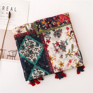 Detail of vintage paisley cotton linen scarf with tassels and colorful floral patterns