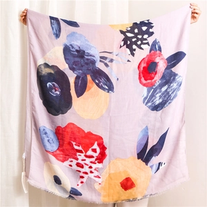 Detail of bohemian ink style scarf with abstract floral patterns and frayed edges